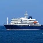 **Tres muertos por presunto brote de hantavirus en crucero que zarpó desde Argentina** Tres personas murieron y otras tres permanecen bajo atención médica tras un posible brote de hantavirus en el crucero MV Hondius, que realizaba una travesía desde Ushuaia, Argentina, hacia Cabo Verde, en África, según informó la Organización Mundial de la Salud. Entre los afectados se encuentra un ciudadano británico de 69 años, único caso confirmado hasta el momento, quien permanece en cuidados intensivos en Johannesburgo, Sudáfrica. Las víctimas mortales eran originarias de Países Bajos, país donde tiene sede la empresa operadora Oceanwide Expeditions. Las autoridades investigan el origen del contagio, ya que el hantavirus suele transmitirse por contacto con orina o heces de roedores infectados, aunque en casos excepcionales puede haber transmisión entre personas. El primer fallecido fue un pasajero de 70 años que murió a bordo, seguido por su esposa, evacuada a Sudáfrica, donde también falleció. La OMS coordina la evacuación médica de otros pasajeros sintomáticos y evalúa los riesgos sanitarios para quienes permanecen en el barco, que continúa detenido frente a la costa de Praia, capital de Cabo Verde. Más información en alodigitalrd.com. #Hantavirus #Crucero #Argentina #Sudáfrica #SaludInternacional #OMS #AloRD #AloDigitalRD #NoticiasRD